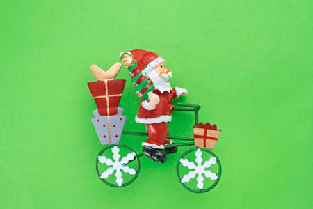 Santa claus with gifts on a bicycle, christmas tree decoration. Selective focusの写真素材