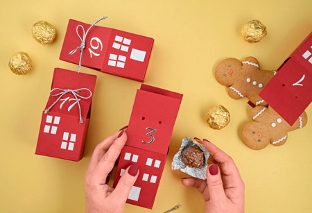 homemade advent calendar made of cardboard boxes with gingerbread men and chocolates, Christmas waiting calendarの写真素材