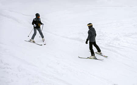unknown unrecognizable skier learns Snowplough skiing techniqueの写真素材