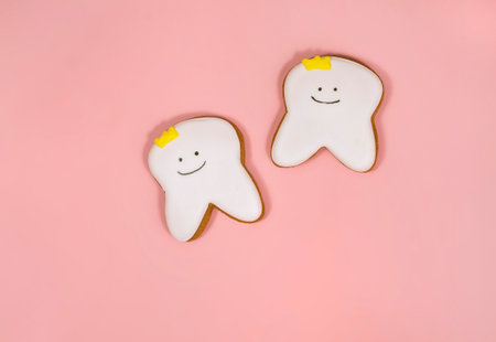 gingerbread in the shape of a tooth, background for the concept of pediatric dentistry and tooth fairyの写真素材