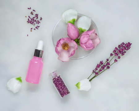 Cosmetic skincare background. Herbal medicine with with green leaves and petals. Petri dishes,...
