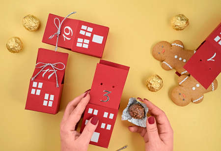 homemade advent calendar made of cardboard boxes with gingerbread men and chocolates, Christmas waiting calendarの写真素材