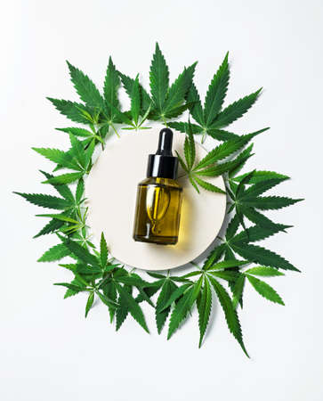 hemp cosmetic oil or serum, treatment for hair and scalp. Medical marijuana CBD oil and green leafの写真素材
