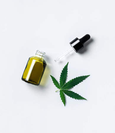 hemp cosmetic oil or serum, treatment for hair and scalp. Medical marijuana CBD oil and green leafの写真素材
