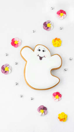 abstract textured background with gingerbread in the shape of a ghost for halloweenの写真素材