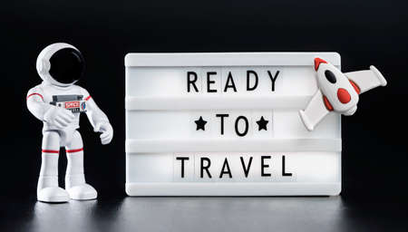 toy astronaut near blackboard with quote ready to travelの写真素材