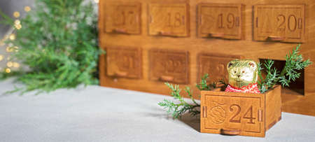 Wooden christmas advent calendar with chocolate bearの写真素材