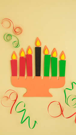 Happy Kwanzaa Greeting Card Background. Candleholder made from paper leaves. Paper art concept. Vertical banner mockupの写真素材
