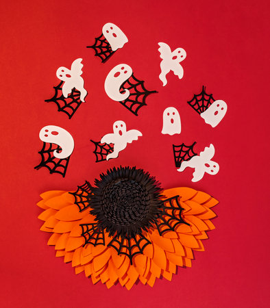 creative halloween background with paper flowers and ghostsの写真素材