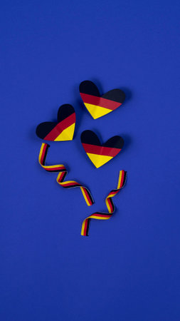 German style abstract background, hearts and ribbon in the colors of the German flagの写真素材