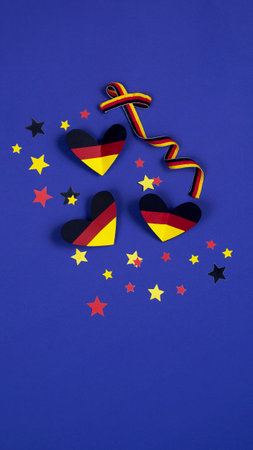 German style abstract background, hearts and ribbon in the colors of the German flagの写真素材