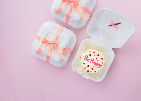 Bento cake with text Be happy in takeout boxの写真素材