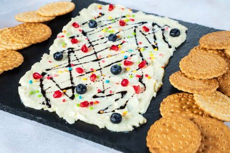 Sweet Butter board topped with chocolate, pomegranate seeds, blueberries.