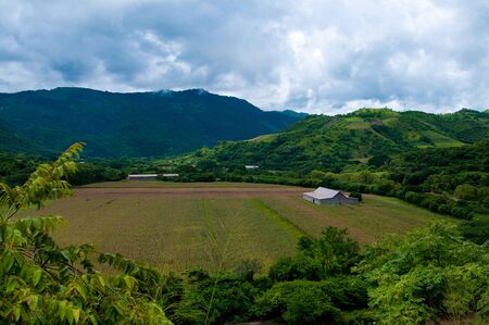 House on the plain between mountains of Nicaraguaの写真素材