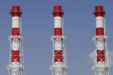 Three industrial color pipes on blue skyの写真素材