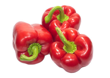 Three red sweet peppers isolated on whiteの写真素材