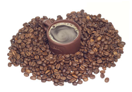 Cup with hot coffe in coffee beans isolated onwhiteの写真素材