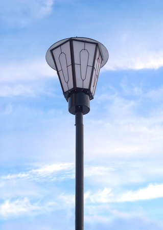 Lantern in front of blue sky with white cloudsの写真素材