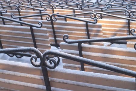 Many vintage wooden benches with snow and iceの写真素材