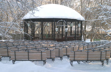 Stage and many vintage wooden benches in a parkの写真素材