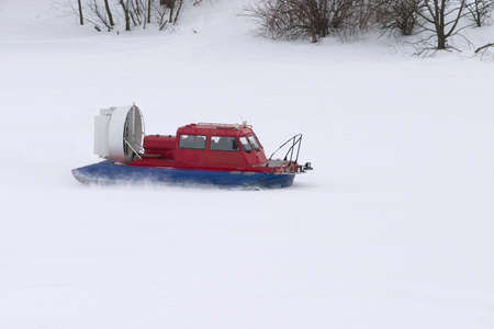 Rescue Service snowmobile patrol on duty in winter on frozen riverの写真素材
