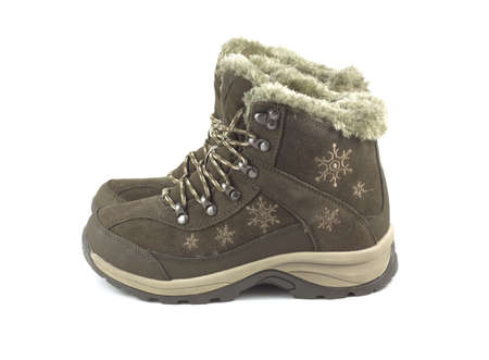 Two beautiful winter brown boots isolated on white side view closeup