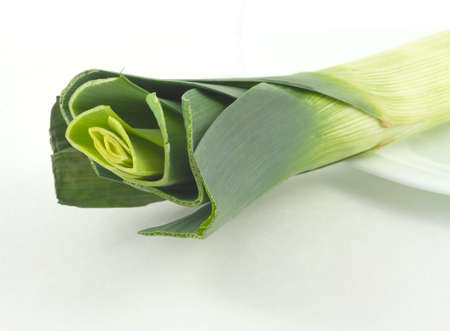 Green Leek on a plate isolated on white diagonal view