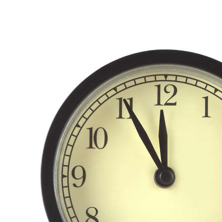 Part of clocks in black case and beige clock face shows 5 minutes to twelve isolated on white close...
