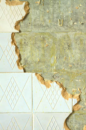 Concrete wall in house with broken ceramic tiles in the process of repair close up
