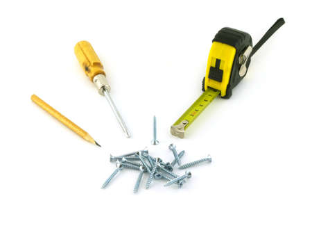 Screwdriver, roulette, screw pile, pencil isolated on white background closeupの写真素材