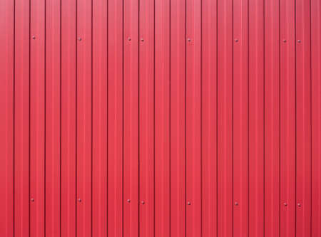 Red metal vertical fence as background closeupの写真素材