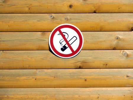 No smoking sign on painted wooden wall of horizontal planks closeupの写真素材