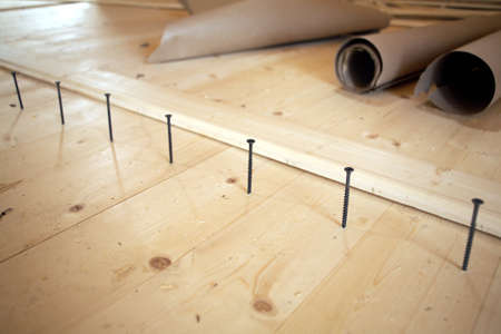 Installation of the floor in a house. Screws lined up before tightening. Diagonal view closeupの写真素材