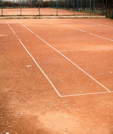 End of summer sport season. Empty tennis courts in autumn parkの写真素材