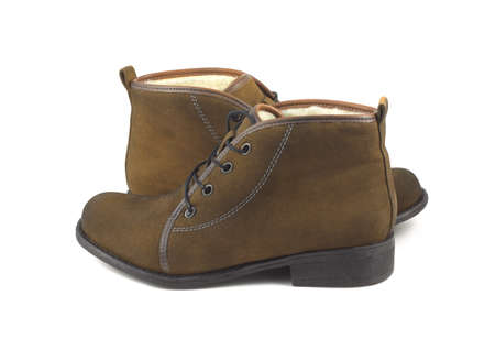Two beautiful female brown suede boots isolated on white side view closeupの写真素材