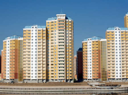 New district with constructed buildings near river over clear cloudless blue sky closeupの写真素材