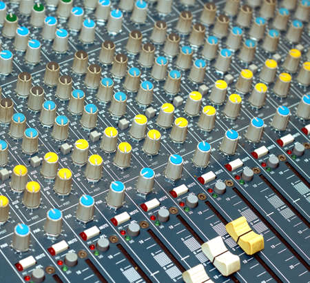 Big multichannel audio sound mixer with many buttons and knobs. Diagonal view closeup