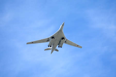 White Swan. Russian military aircraft supersonic bomber with variable sweep wing Tu160 in flight against blue skyのeditorial素材