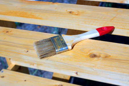 Brush lying on a painted wooden shelving surface. Photo closeupの写真素材