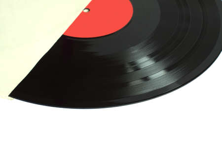 Black long-play vinyl record with red label from the paper sleeve isolated on white background. Photo closeupの写真素材