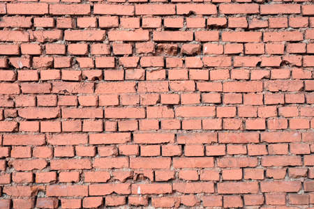 Old red brick wall as background horizontal view closeup
