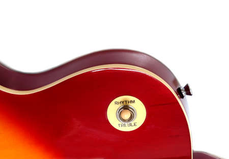 Part of vintage electric guitar sunburst color with arc top isolated on white background vertical...