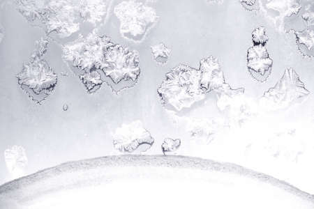 Beautiful hoarfrost tracery on frozen window a frosty day indoor horizontal view closeupの写真素材