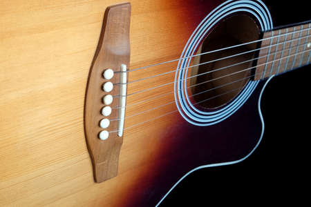 Classic acoustic six strings guitar sunburst color top from spruce with cutaway fragment isolated on...