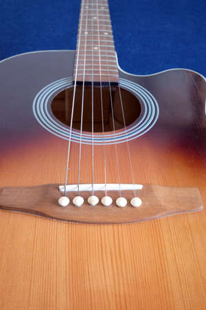 Classic acoustic six strings guitar sunburst color top from spruce with cutaway fragment isolated on...