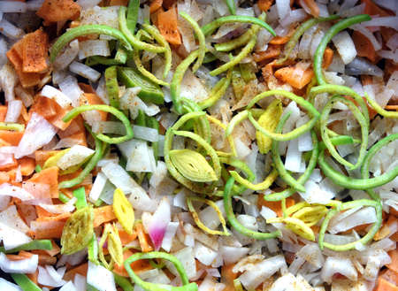 Still life with sliced ??carrots, onion, leek and fragrant spices on kitchen before frying as background top view horizontal close upの写真素材