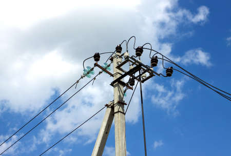 Prop top of power supply line over blue sky with white clouds