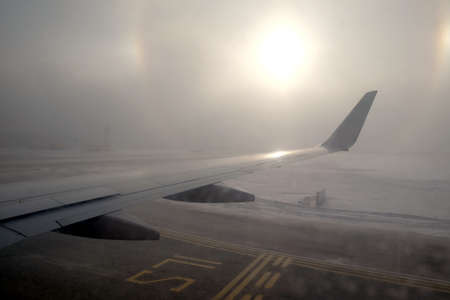 Passenger plane takes off from the runway aerodrome with road marking in winter in bad weather...