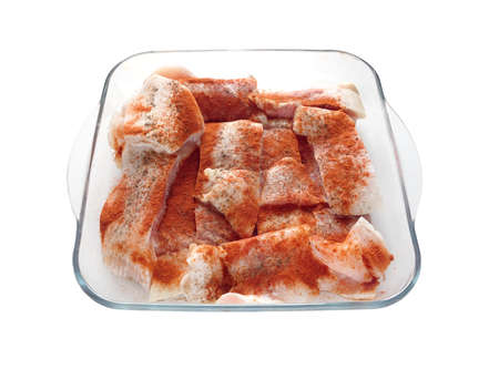 Many raw juicy sliced â€‹â€‹fish fillets pink well sprinkled with red pepper inside square...