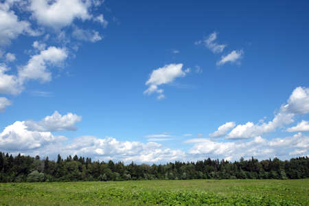 Beautiful countryside landscape with blue sky and clouds on a white background